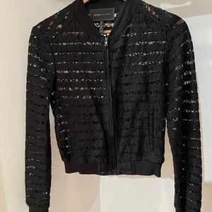 Black lace jacket with pockets.